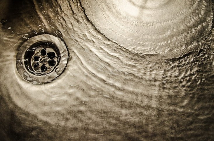 water draining in a stainless steel sink