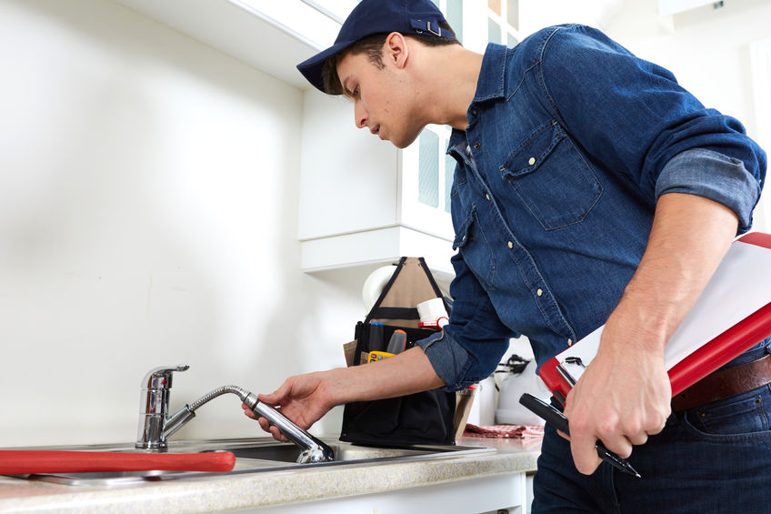 A technician inspecting a kitchen hose
