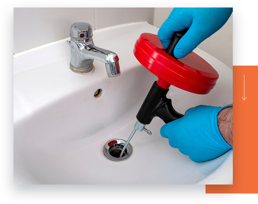 A technician clearing a clogged bathroom sink drain